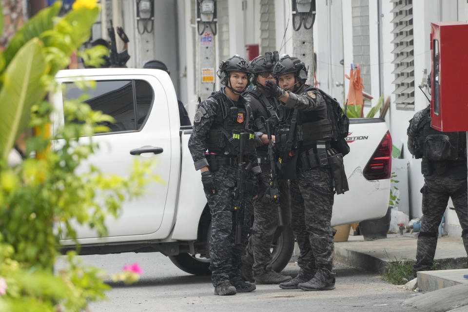 Members of the armed commando police are seen outside a home of a senior police officer in Bangkok, Thailand, Wednesday, March 15, 2023. Thai police on Wednesday detained the senior police officer who fired multiple gunshots from his home in Bangkok, ending a standoff of over 24 hours after his colleagues tried to take him to be treated for mental illness. (AP Photo/Sakchai Lalit)