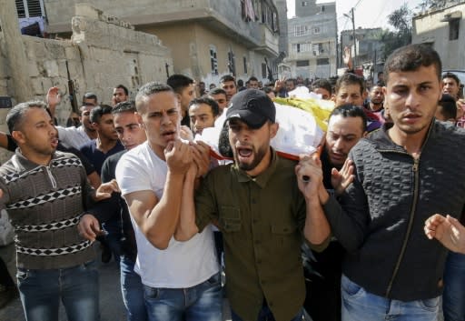 Mourners carry the body of 27-year-old Palestinian Ahmed al-Shahri, killed during an Israeli airstrike, during his funeral in Khan Yunis in the southern Gaza Strip on Saturday