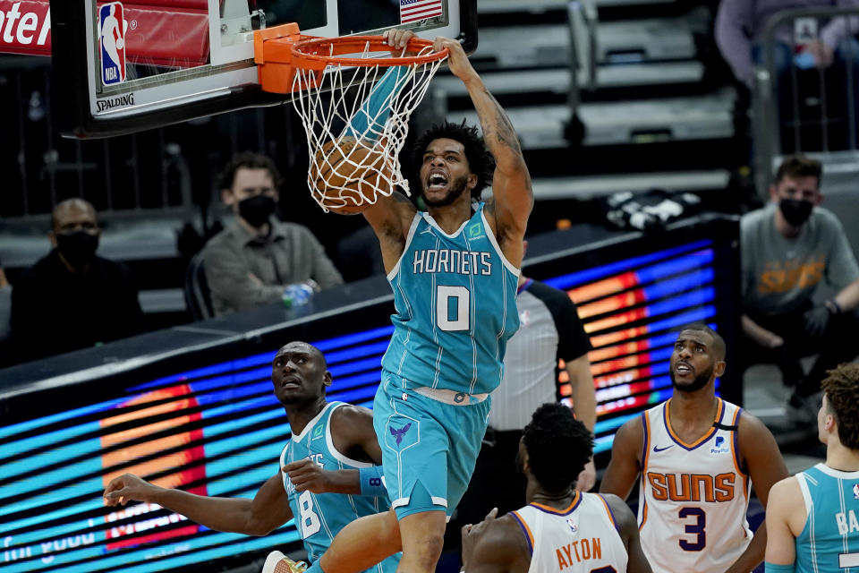 Charlotte Hornets forward Miles Bridges (0) dunks against the Phoenix Suns during the second half of an NBA basketball game, Wednesday, Feb. 24, 2021, in Phoenix. (AP Photo/Matt York)