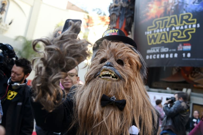 A man in a Chewbacca costume takes a selfie in front of the TCL Chinese Theatre, December 17, 2015 in Hollywood, California