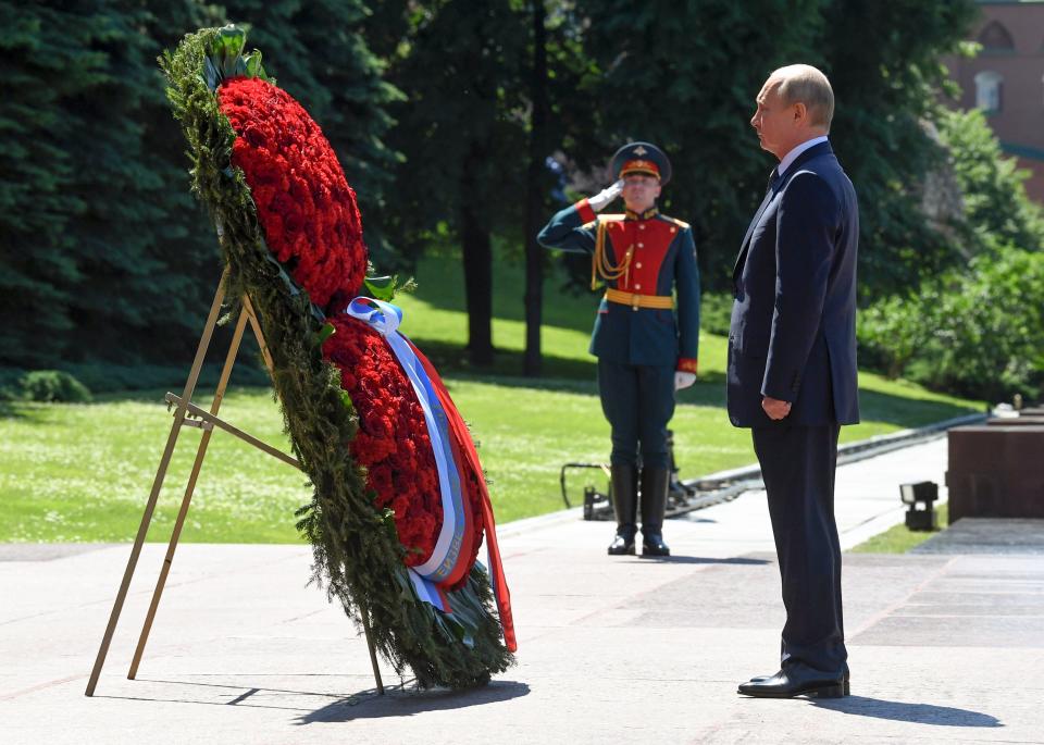Russian President Vladimir Putin stands during a minute of silence in memory of those killed during WWII as he takes part in a wreath laying ceremony at the Tomb of Unknown Soldier in Moscow, Russia, Monday, June 22, 2020, marking the 79th anniversary of the Nazi invasion of the Soviet Union. (Alexei Nikolsky, Sputnik, Kremlin Pool Photo via AP)