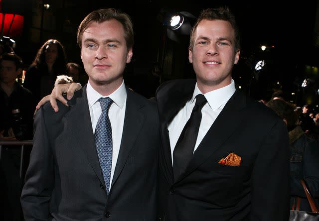 <p>E. Charbonneau/WireImage</p> Christopher Nolan and his brother Jonathan Nolan pose for a photo at an event.