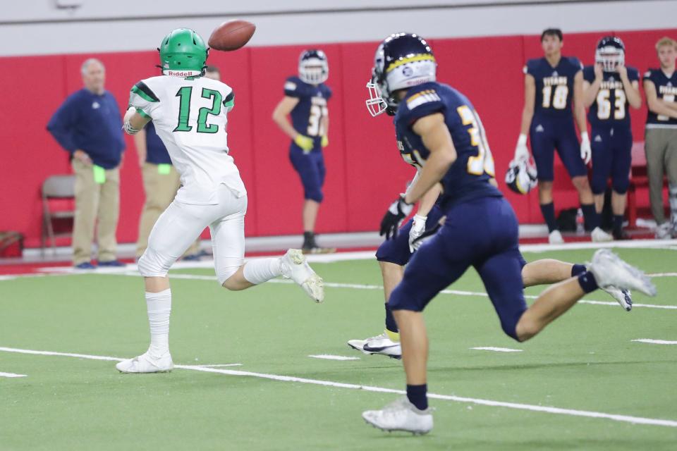 Pierre Governors WR Jett Zabel (12) catches a pass before scampering to the end zone for a score Friday night in the DakotaDome during the 11AA State Championship game against the Tea Area Titans.  Pierre won 30-27.