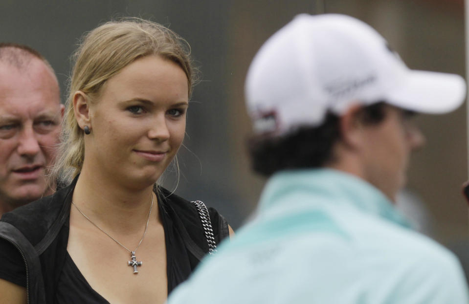 Caroline Wozniacki of Denmark watches her boyfriend Rory McIlroy of Northern Ireland after McIlroy finishes the 18th green at the HSBC Champions golf tournament in Shanghai, China on Nov. 5. McIlroy finished the third day with 12 under. (AP Photo/Eugene Hoshiko)