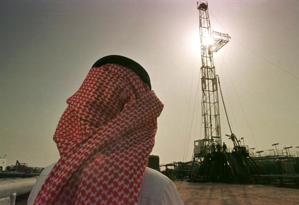 FILE - In this Feb. 26, 1997 file photo, Khaled al-Otaiby, an official of the Saudi oil company Aramco, watches progress at a rig at the al-Howta oil field near Howta, Saudi Arabia. Saudi Arabia said on Thursday, Aug. 23, 2018 that it "remains committed" to an initial public offering of the state-run oil behemoth Saudi Aramco despite delays and growing speculation it may never be listed. (AP Photo/John Moore, File)