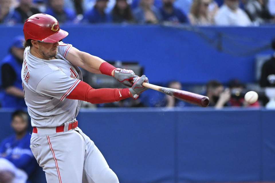 Cincinnati Reds' Kyle Farmer hits a double against the Toronto Blue Jays during the second inning of a baseball game Friday, May 20, 2022, in Toronto. (Jon Blacker/The Canadian Press via AP)