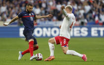 FILE - France's Karim Benzema, left, challenges for the ball with Denmark's Victor Nelsson during the UEFA Nations League soccer match between France and Denmark at the Stade de France in Saint Denis near Paris, France, Friday, June 3, 2022. (AP Photo/Jean-Francois Badias, File)