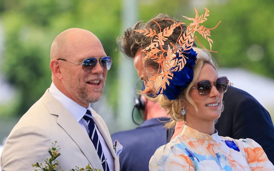 Mike Tindall tries on wife Zara’s hat at the races Down Under