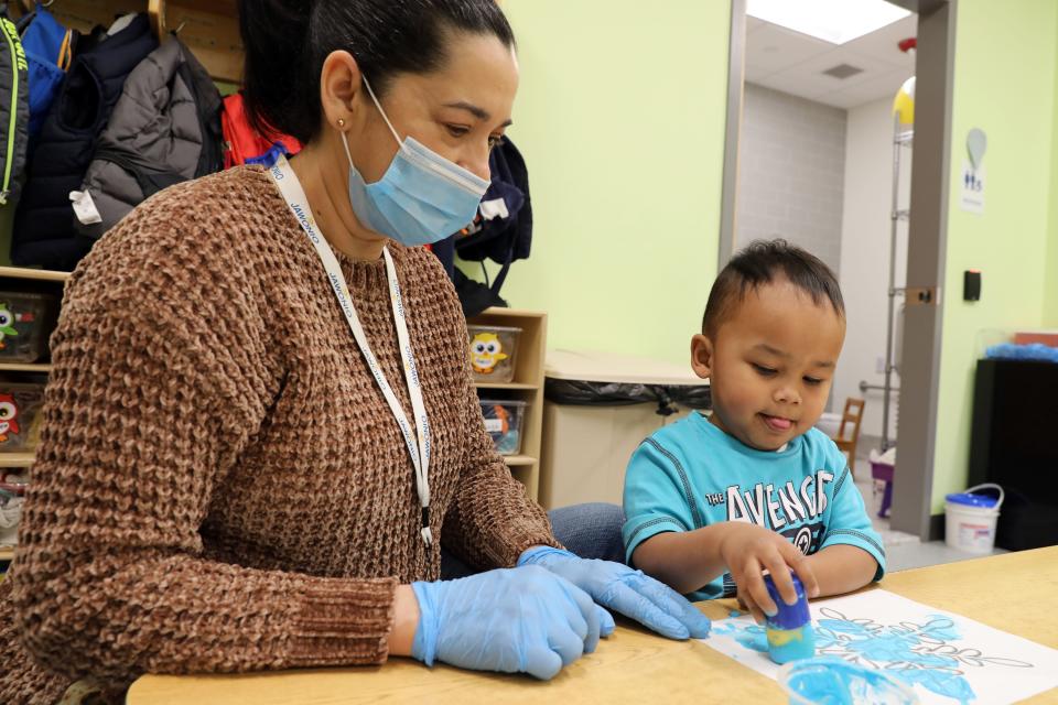 Teaching assistant Anna Metz works with Zavion to paint snowflakes during early intervention class at Jawonio in New City March 2, 2023.