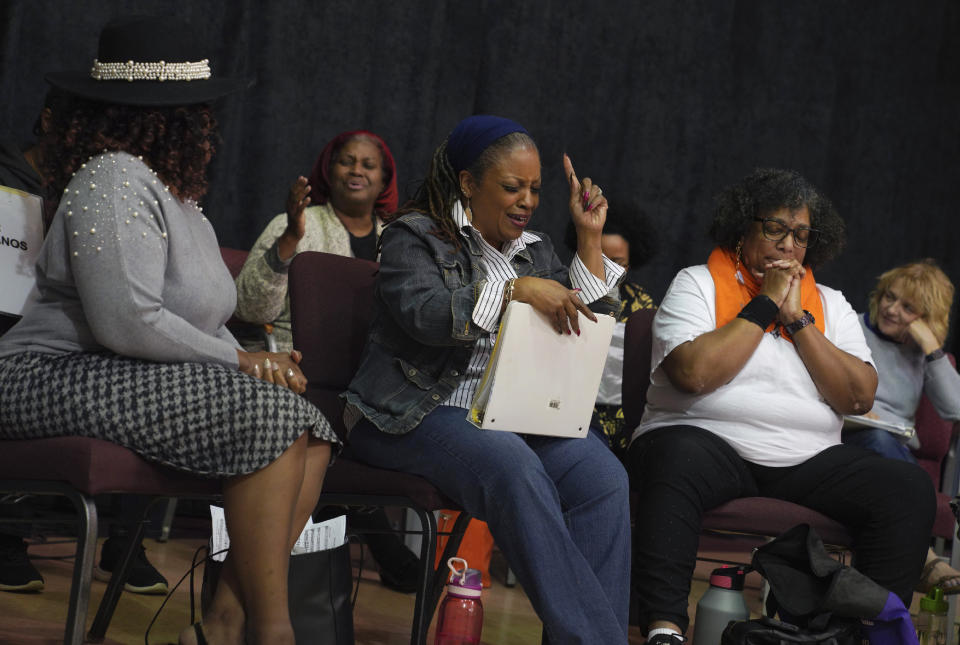 Members of The Heritage Gospel Chorale of Pittsburgh, a multi-ethnic and multi-generational choral ensemble specializing in the performance of African American sacred music, gospel music and spirituals, pray after rehearsal at Bethany Baptist Church in Pittsburgh, on Monday, March 6, 2023. The choir will be one of two performers at an upcoming concert honoring the late gospel composer, musician and publisher, Charles Henry Pace, who's being newly recognized as one of the early pioneers of African American gospel composition and publishing. (AP Photo/Jessie Wardarski)