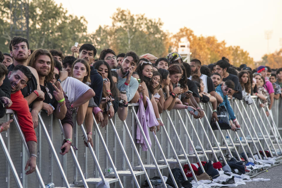 Festival goers are seen waiting behind a fence at day one of the Astroworld Music Festival. It is unknown if any of those pictured were injured or killed. Source: Photo by Amy Harris/Invision/AP