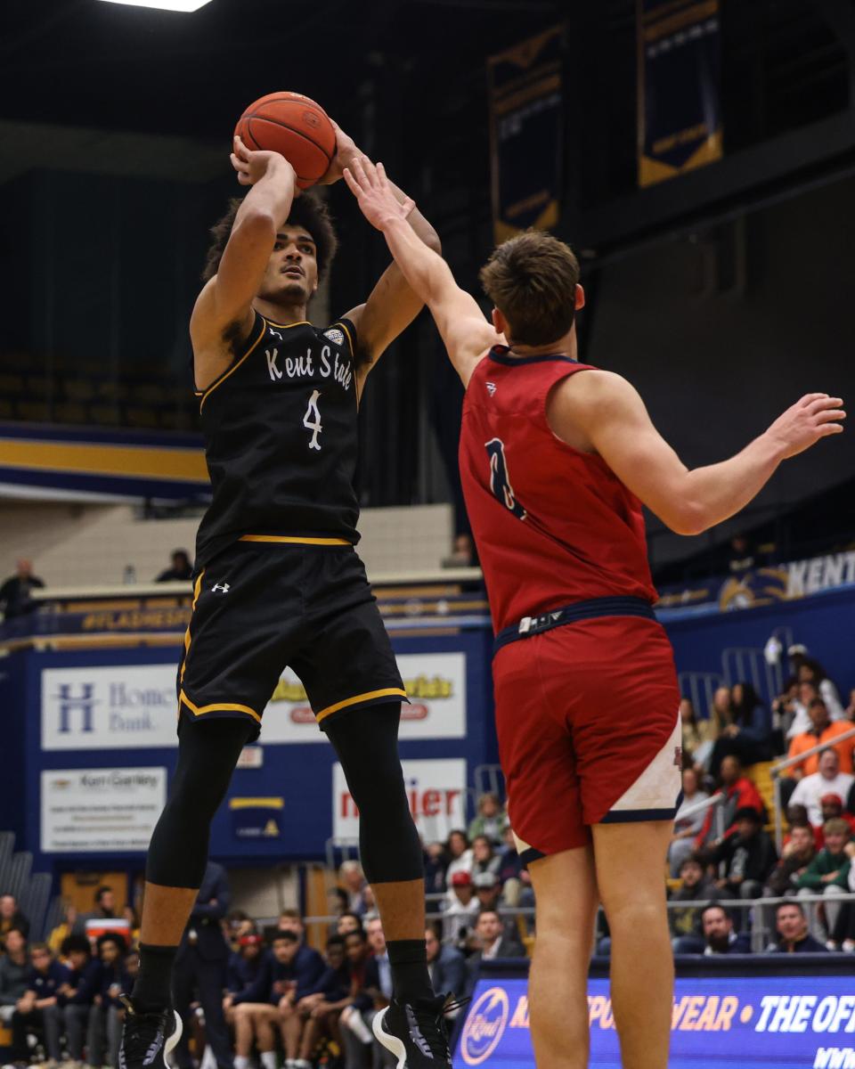 Kent State forward Chris Payton Jr. hits. a jump shot while Malone center Caleb Conard goes up to defend during Monday's game at Kent State.