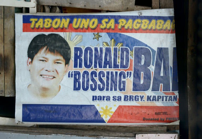 A campaign poster showing an image of Ronaldo Bae, who once ran in local elections for the post of village chief, hanging from a shanty house in Kawit, south of Manila, on January 4, 2013. Bae allegedly went on a rampage and killed five people on Friday, before dying in a gunbattle with police