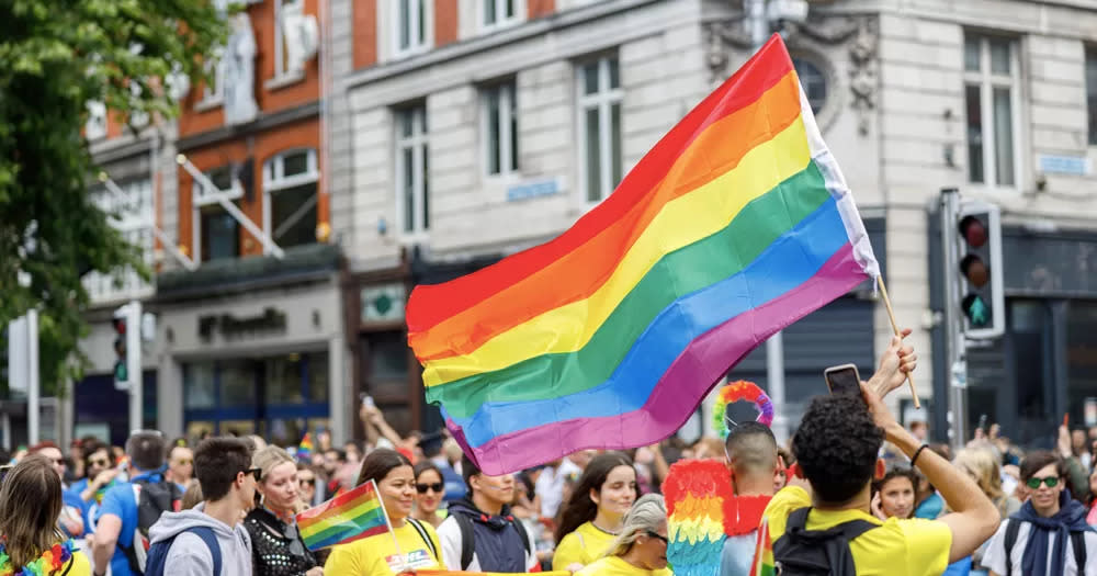 This article is about the rise of anti-LGBTQ+ rhetoric in Ireland. In the photo, people marching at Dublin Pride, with a big Pride flag in the centre of the image.