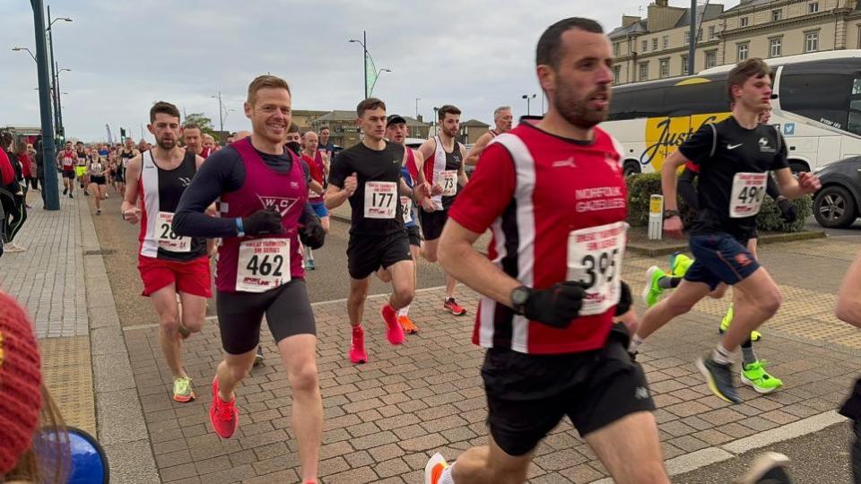 Eastern Daily Press: Mark Armstrong is all smiles as he sets off at the start of the Yarmouth 5M event