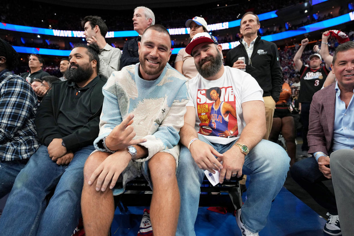 Travis Kelce and Jason Kelce attend a basketball game in 2023. (Jesse D. Garrabrant / Getty Images)