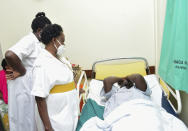 Nurses attend to Mityana Municipality politician, Zaake Francis, close ally to opposition leader Bobi Wine in Rubaga hospital, Kampala, Uganda, Sunday, Jan. 17, 2021, after he was alledgedly beaten by security personnel at the gates of Bobi Wine's house on Saturday. A day after Uganda’s longtime leader was declared the winner of the country’s presidential election, the opposition party dismissed the results as “fraud” and called for the release of their leader, Bobi Wine, who has been under alleged house arrest for several days. (AP Photo/Nicholas Bamulanzeki)