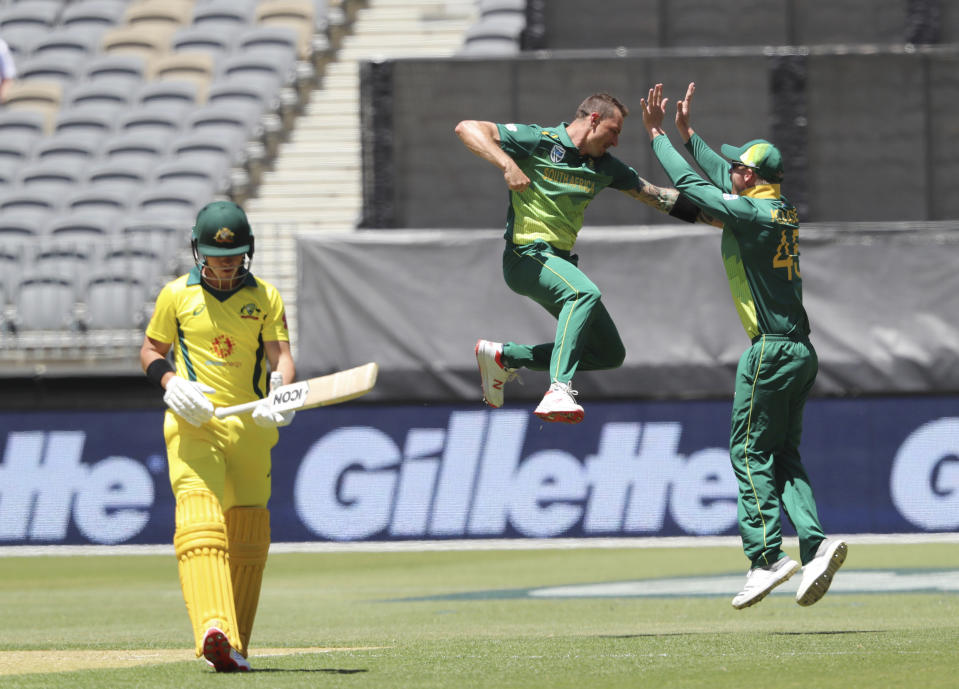 South Africa's Dale Steyn, center, celebrates with teammate Heinrich Klaasen after capturing the wicket of Australia's D'Arcy Short during their one day international cricket match in Perth, Australia Sunday, Nov. 4, 2018. (AP Photo/Trevor Collens)