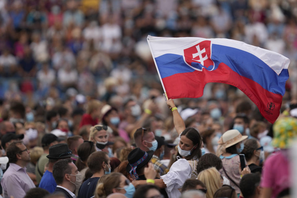 Faithful wait for Pope Francis at Lokomotiva Stadium in Košice, Slovakia, Tuesday, Sept. 14, 2021. Francis first trip since undergoing intestinal surgery in July, marks the restart of his globetrotting papacy after a nearly two-year coronavirus hiatus. (AP Photo/Darko Vojinovic)