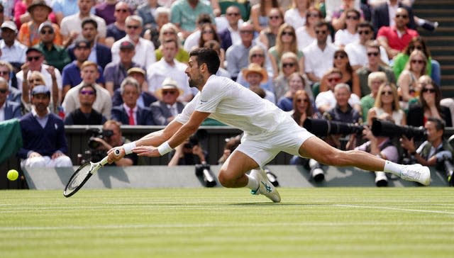 Novak Djokovic dives for a shot