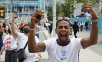 An England fan cheers outside Wembley Stadium in London, Sunday, July 11, 2021, prior to the Euro 2020 soccer championship final match between England and Italy. (AP Photo/David Cliff)