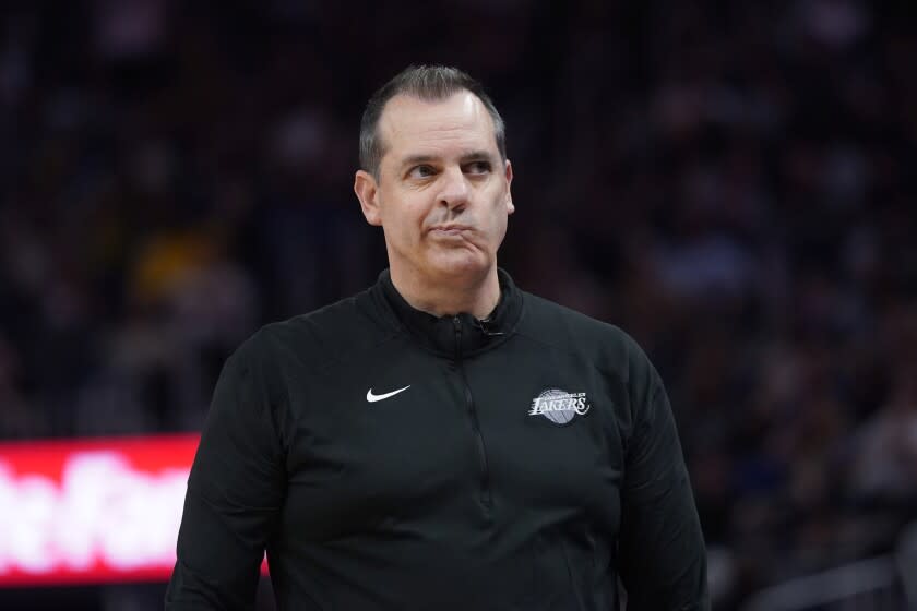 Los Angeles Lakers coach Frank Vogel walks along the sideline during the second half.