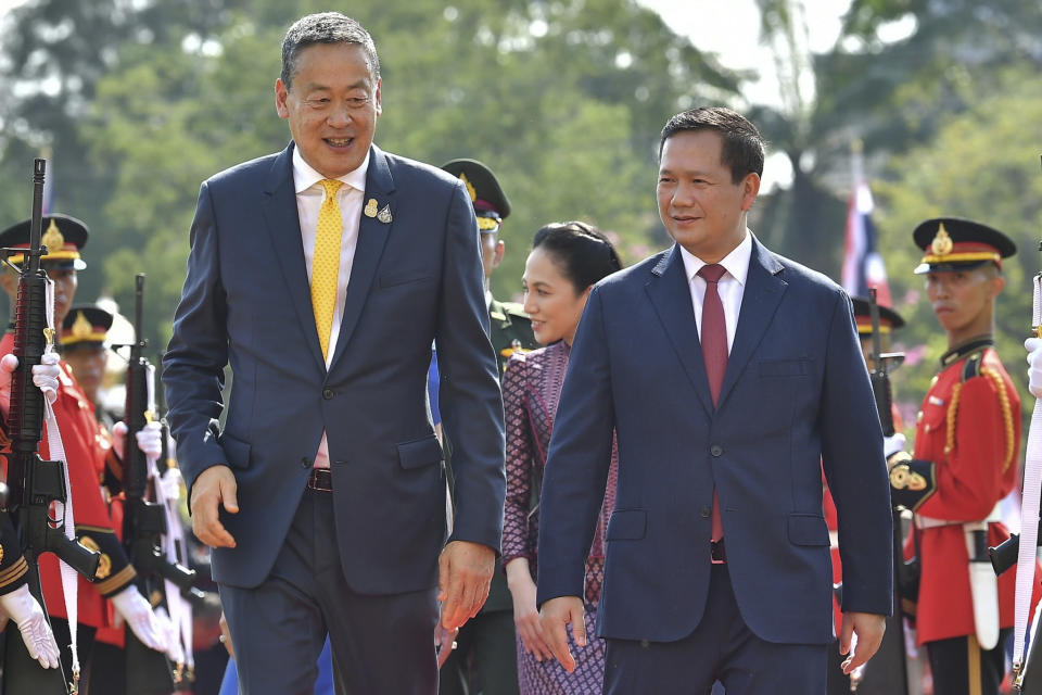 In this photo released by the government spokesman office, Thailand's Prime Minister Srettha Thavisin, left, escorts Cambodia's Prime Minister Hun Manet after they review an honor guard during a welcoming ceremony at the government house in Bangkok, Thailand, Wednesday, Feb. 7, 2024. (Government Spokesman Office via AP)