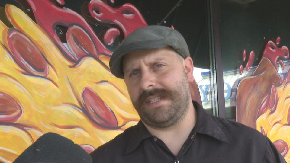 Pizza chef Dean Litster answers interview questions outside his pizzeria, Armando's Amherstburg.