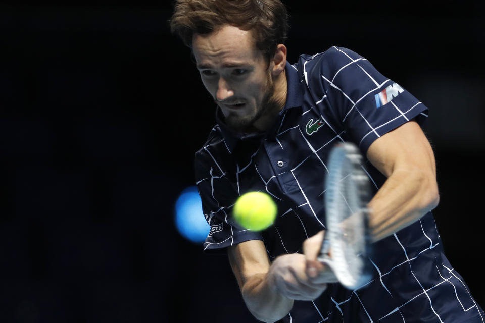 Daniil Medvedev of Russia plays a return to Diego Schwartzman of Argentina during their singles tennis match at the ATP World Finals tennis tournament at the O2 arena in London, Friday, Nov. 20, 2020. (AP Photo/Frank Augstein)