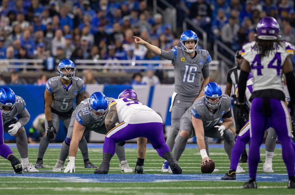 Detroit Lions quarterback Jared Goff calls a play at the line of scrimmage with center Frank Ragnow and left guard Graham Glasgow against the Minnesota Vikings defense at Ford Field in Detroit on Sunday, Jan. 7, 2024.