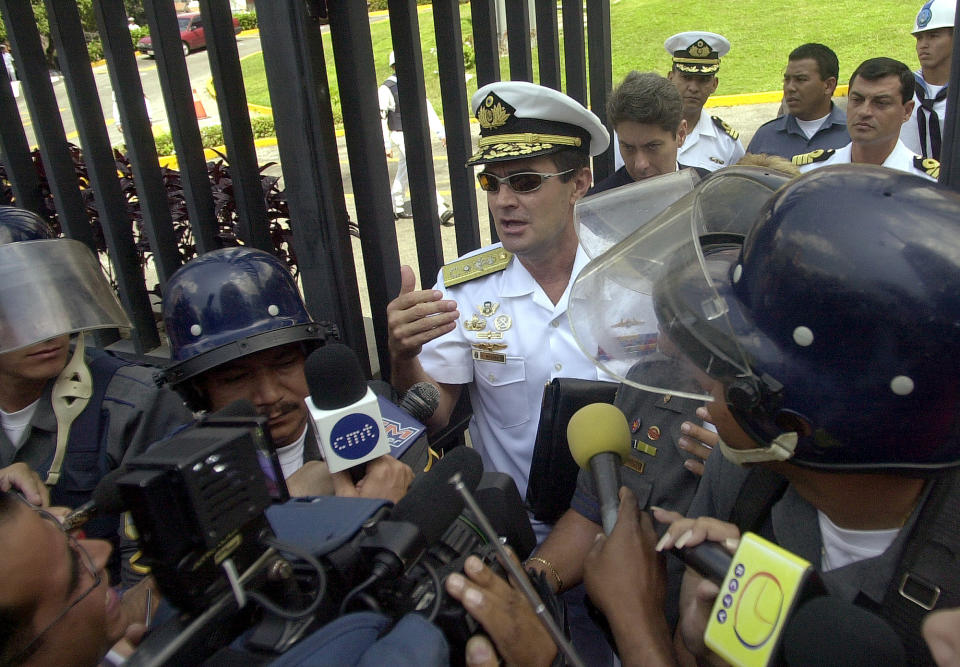 Venezuelan Navy Vice Adm. Carlos Molina Tamayo, center, speaks with the media at Navy Headquarters in Caracas, Venezuela, in February 2002, less than two months before the coup. (Photo: Fernando LLano/AP)