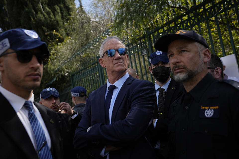 Former Defense Minster Benny Gantz stands as Israelis protest against Prime Minister Benjamin Netanyahu's judicial overhaul plan outside the parliament in Jerusalem, Monday, March 27, 2023. (AP Photo/Ohad Zwigenberg)