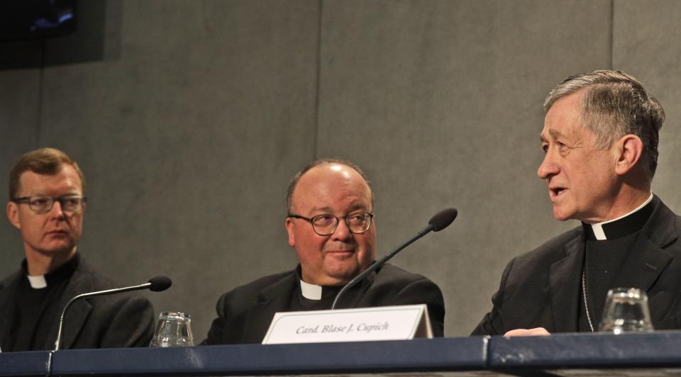 Cardinal Blase J. Cupich, Chicago Archbishop, right, speaks as Mons. Charles Scicluna, Malta Archbishop, and Rev. Hans Zollner, left, listen during a press conference on a Vatican summit on preventing clergy sex abuse, at the Vatican, Monday, Feb. 18, 2019. Organizers of Pope Francis' summit on preventing clergy sex abuse will meet this week with a dozen survivor-activists who have come to Rome to protest the Catholic Church's response to date and demand an end to decades of cover-up by church leaders. (AP Photo/Gregorio Borgia)