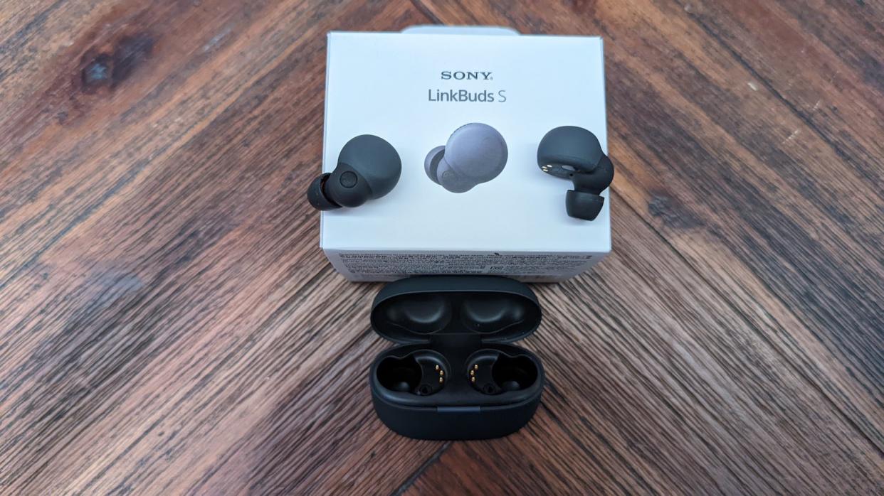 Black Sony LinkBuds S earbuds on it's packaging, together with its charging case on top of a wooden table. (Photo: Yahoo Lifestyle Singapore)