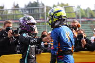 Third placed McLaren's Lando Norris, right, is greeted by second placed Mercedes' Lewis Hamilton at the end of the Emilia Romagna Formula One Grand Prix, at the Imola racetrack, Italy, Sunday, April 18, 2021. (Bryn Lennon/ Pool Via AP)