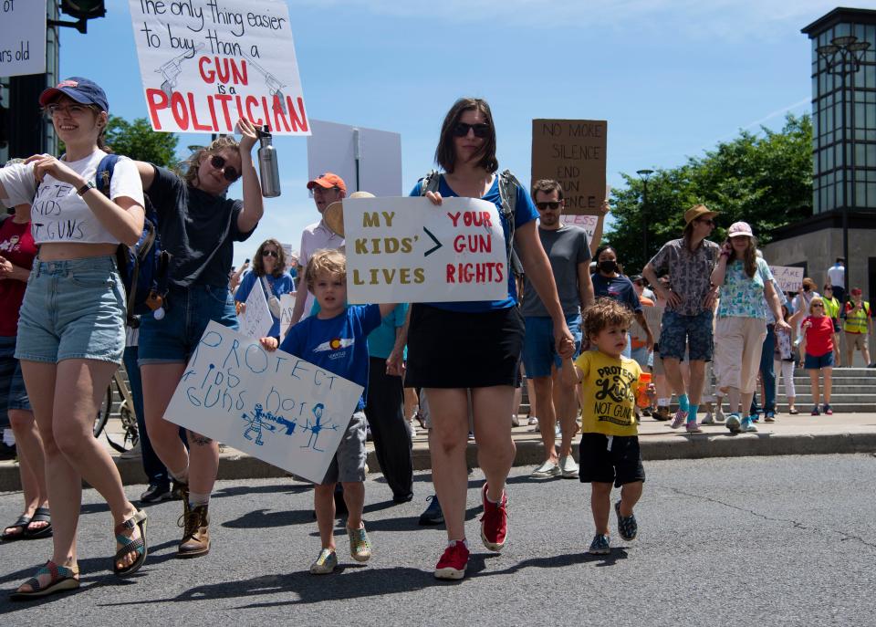 Wesley Heckert, 2, walks with Lacey Kohlmoos and Finn Heckert, 5, during the March for Our lives protest in Nashville, Tenn., Saturday, June 11, 2022. The march was part of a nation wide protest advocating for stricter gun control laws. 