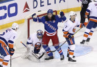 New York Rangers' Mika Zibanejad (93) celebrates a first-period goal by Pavel Buchnevich, not seen, against New York Islanders goalie Ilya Sorokin in an NHL hockey game Saturday, Jan. 16, 2021, in New York. (Bruce Bennett/Pool Photo via AP)