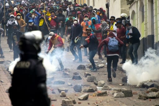 Demonstrators clash with riot police in Quito, as thousands march against President Lenin Moreno's decision to slash fuel subsidies