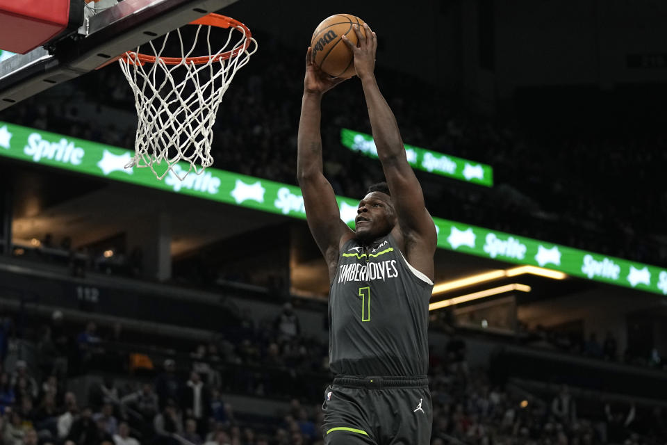 Minnesota Timberwolves guard Anthony Edwards (1) goes up for a dunk during the first half of an NBA basketball game against the Denver Nuggets, Sunday, Feb. 5, 2023, in Minneapolis. (AP Photo/Abbie Parr)