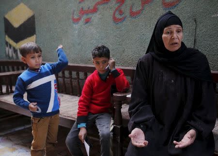 Fathia Hashem, mother of Amr Abushanab, who died in police custody, speaks with Reuters next to Abushanab's sons Mohamed (L) and Abd-Elrahman during an interview at their house in Tahanoub village November 30, 2015. REUTERS/Amr Abdallah Dalsh