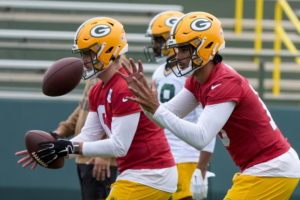 Green Bay Packers' Jordan Love and Sean Clifford run a drill during an NFL football practice Tuesday, May 21, 2024, in Green Bay, Wis. (AP Photo/Morry Gash)