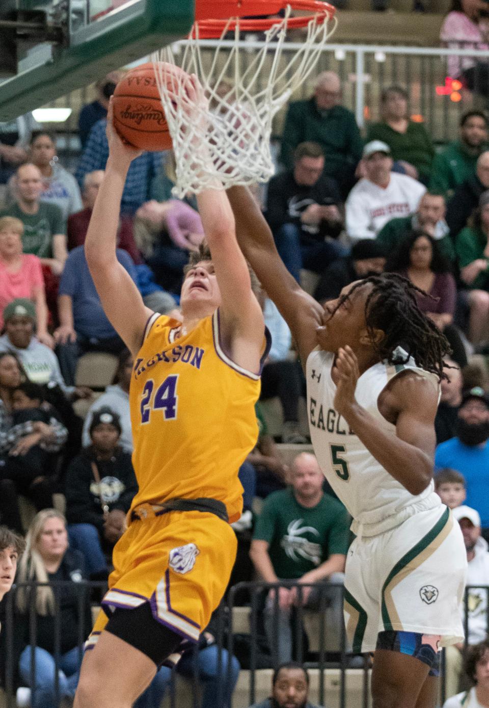 Jackson's Kyle Monterrubio draws the foul from GlenOak's Katour Ashcraft in the first half at GlenOak, Tuesday, January 3, 2023.