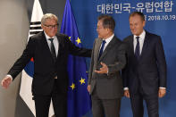 European Commission President Jean-Claude Juncker, left, and European Union Council President Donald Tusk, right, greet South Korea's President Moon Jae-in during the EU-ASEM leaders summit in Brussels, Friday, Oct. 19, 2018. (Toby Melville, Pool Photo via AP)