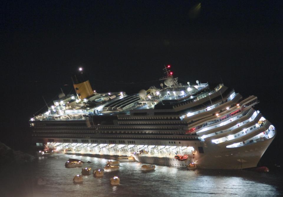 FILE - In this picture taken on Jan. 13, 2012, the luxury cruise ship Costa Concordia lays on its starboard side after it ran aground off the coast of the Isola del Giglio island, Italy, gashing open the hull and forcing some 4,200 people aboard to evacuate aboard lifeboats. The phrase "Women and children first" and all it implies about whom to save first in a disaster is rooted in the shipwrecks of centuries past and popularized by Hollywood's treatment of the Titanic disaster is getting another airing at a time when women are expected to do most everything men do. Experts say the unwritten law of the sea is a Hollywood-fed myth and a relic of Victorian-era chivalry. At the center of this round of questions is the prisoners-for-hostages deal between Israel and Hamas last month that prioritized releasing women and children after negotiators agreed that mothers and their children should not be separated. (AP Photo/Giuseppe Modesti)