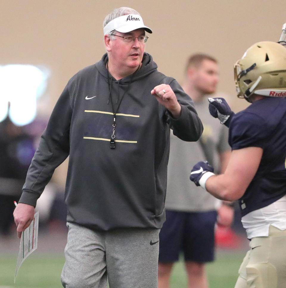 University of Akron head coach Joe Moorhead fist bumps linebacker Bubba Arslanian as he comes off the field during the team's Spring Game on Saturday April 30, 2022 in Akron, Ohio, at Stile Field House.