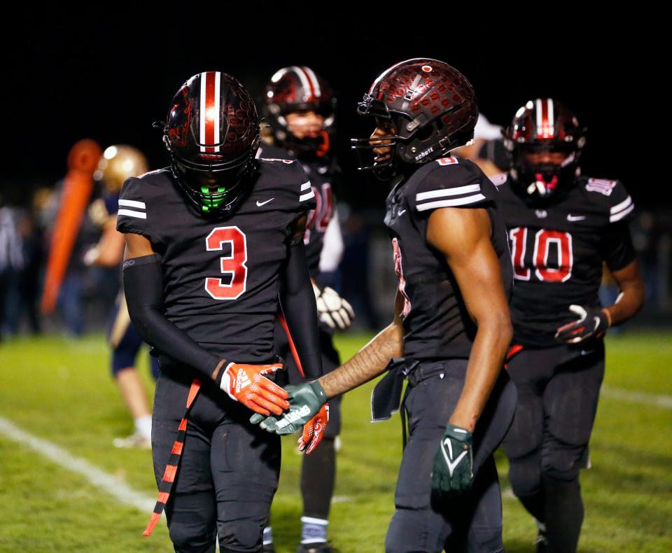 NorthWood seniors NiTareon Tuggle (3) and JoJo Edmond celebrate after the Panthers' defense made a fourth-down stop during the Class 4A football regional championship game against New Prairie Friday, Nov. 10, 2023, at NorthWood High School in Nappanee.