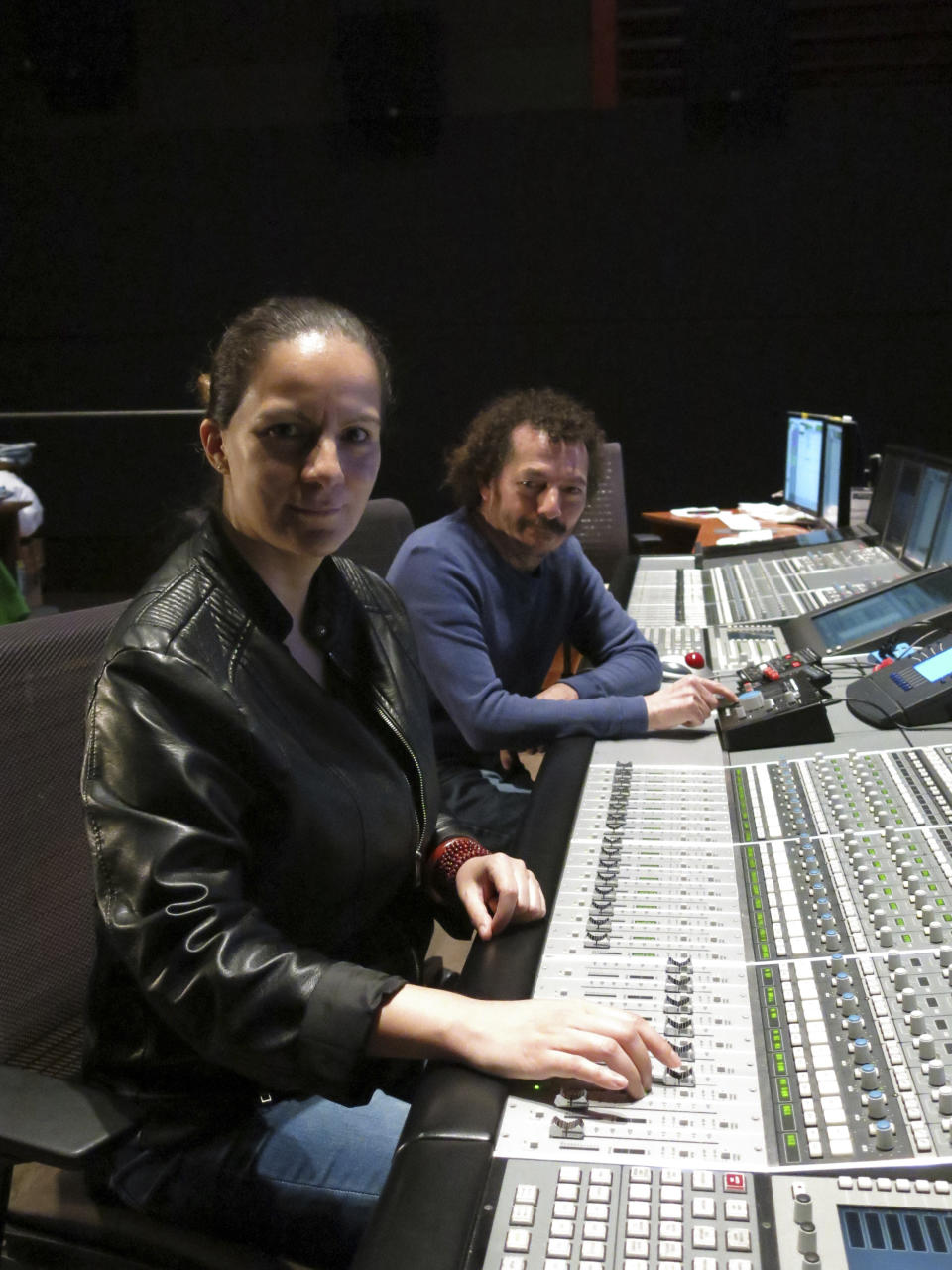 Mexican sound engineers Michelle Couttolenc, left, and Jaime Baksht pose in a sound studio in Mexico City, March 18, 2021. The Oscar-nominated movie “Sound of Metal,” about a heavy metal drummer that starts going deaf, has three Mexican sound engineers nominated for best sound, Couttolenc and Baksht. (AP Photo/Berenice Bautista)