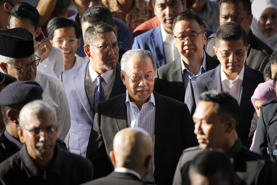 Malaysia's former Prime Minister Muhyiddin Yassin, center, arrives at courthouse for a corruption charges in Kuala Lumpur, Malaysia, Friday, March 10, 2023. Muhyiddin, who led Malaysia from March 2020 until August 2021, will be the country's second leader to be indicted after leaving office. (AP Photo/Vincent Thian)