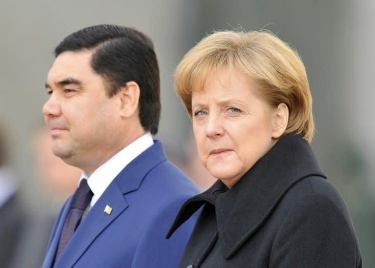 German Chancellor Angela Merkel (R) and Turkmenistan's President Gurbanguly Berdymukhamedov attend an official ceremony in Berlin in 2008