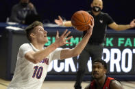 Arizona forward Azuolas Tubelis (10) shoots over Eastern Washington guard Kim Aiken Jr. during the first half of an NCAA college basketball game, Saturday, Dec. 5, 2020, in Tucson, Ariz. (AP Photo/Rick Scuteri)